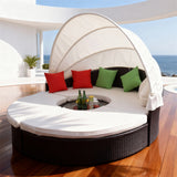 TYSF2606 Black Rattan Round Enclosed Outdoor Daybed with White Canopy, Center Bar & Red-Green Pillows – Los Cabos Mexico Coastal Terrace Luxury Vibrant Outdoor Round Daybed